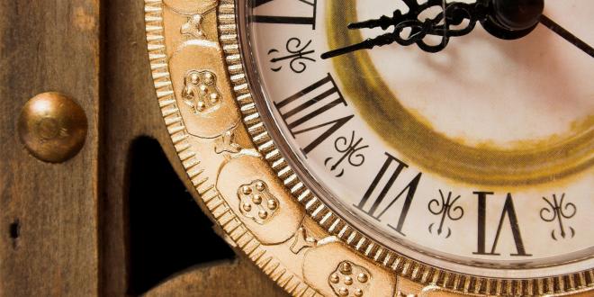 Old wooden clock showing time, close-up.