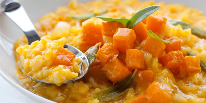 a bowl of risotto with chopped pumpkin on top